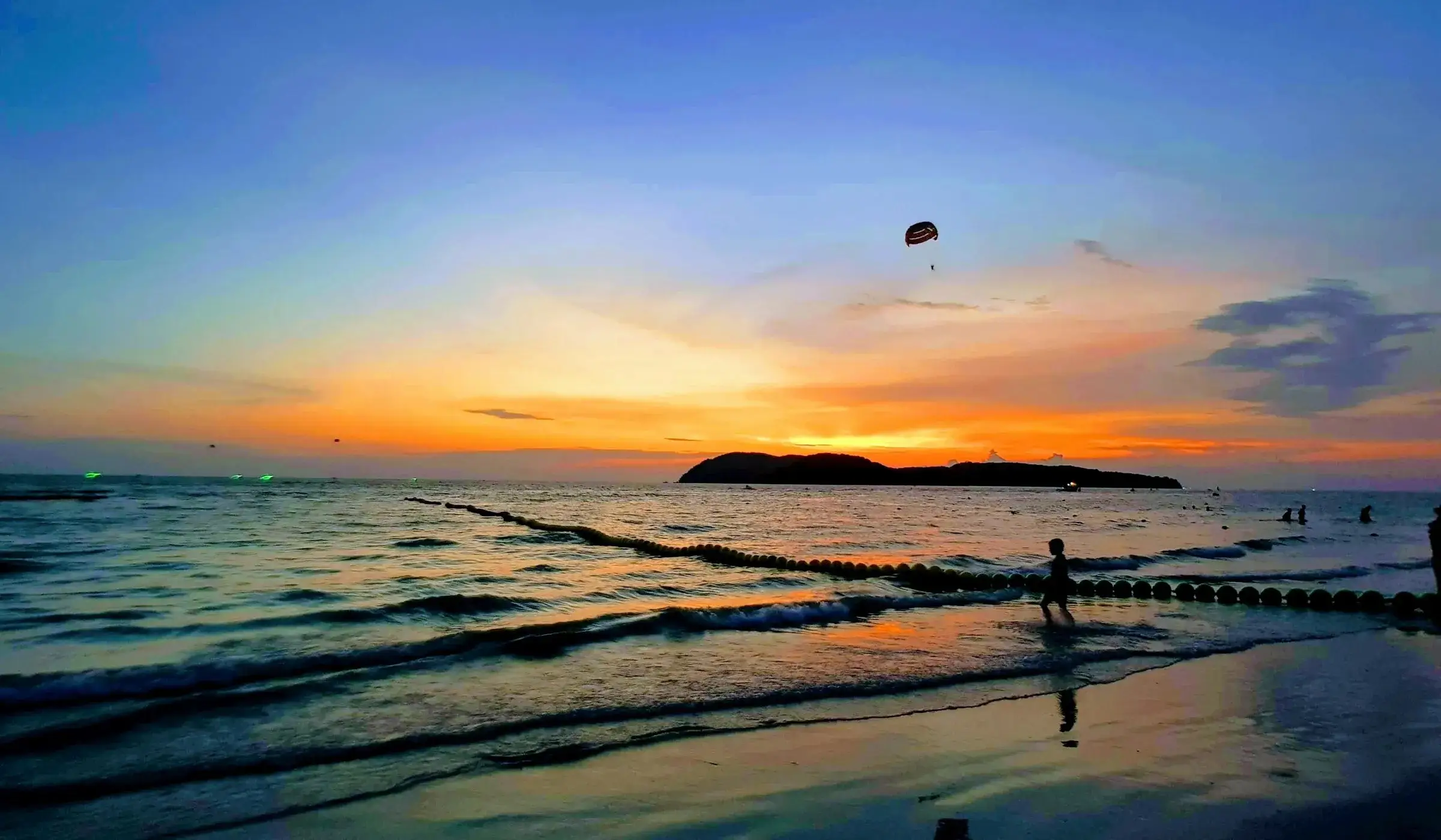A parasail over Pantai Cenang at sunset